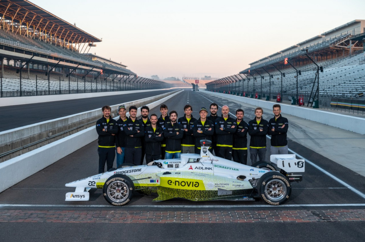 photo of the Crimson Autonomous Racing Team with the Indy Autonomous car